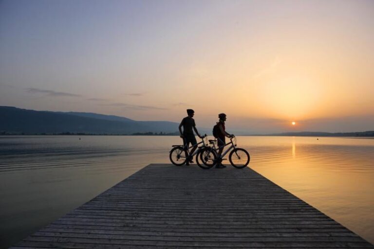 Cyclistes au bord du lac de Bienne au coucher du soleil